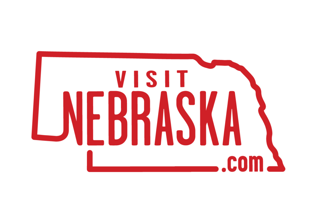 Visit Nebraska Logo .COM Guardsmant Red OneColor